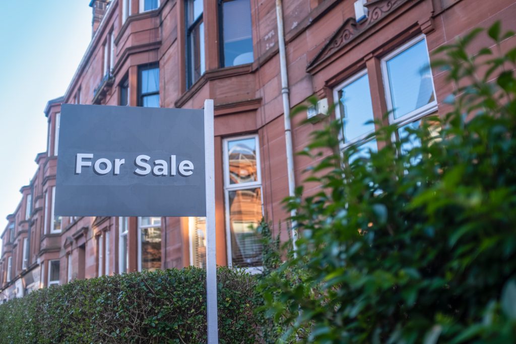 A house with a for sale sign outside where the buyers need mortgage protection insurance.